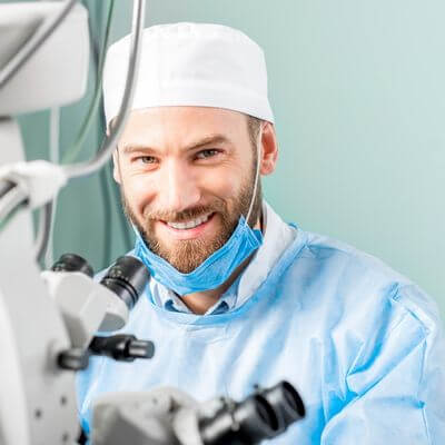 male eye surgeon in an operating room