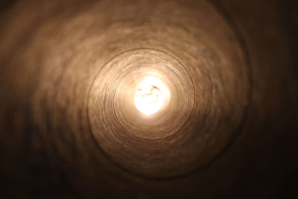 A tunnel with light at the end symbolizing the loss of peripheral vision