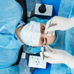 caucasian woman in surgical gown, hairnet, and face mask being prepared for lasik surgery in Tennessee