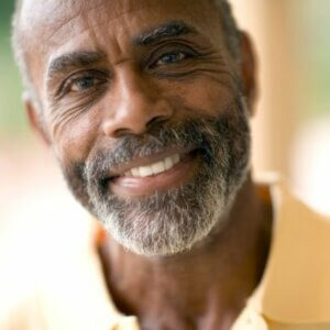 Older man outside and smiling