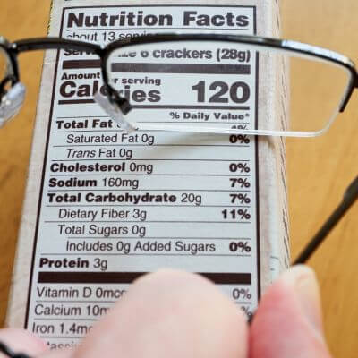 cheap reading glasses laying on top of a food label